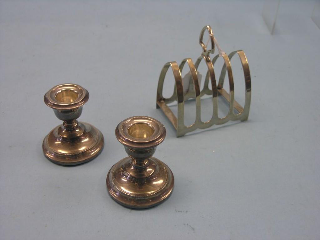 Appraisal: A silver toast rack Sheffield and a small pair of