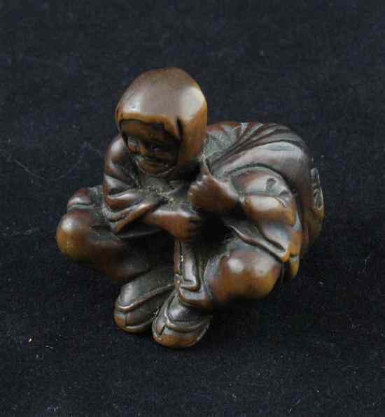 Appraisal: An Edo period hardwood netsuke carved as a smiling man