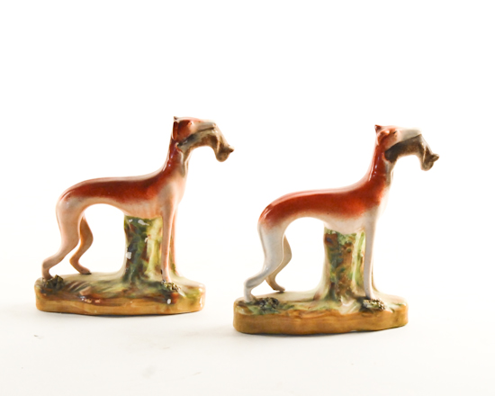 Appraisal: A Pair of Staffordshire Whippets with Rabbits paint loss to