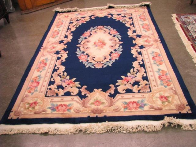 Appraisal: Oriental area rug Chinese design navy and beige hand knotted