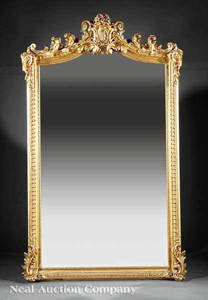 Appraisal: A Louis XV-Style Giltwood Overmantel Mirror th c arched foliate