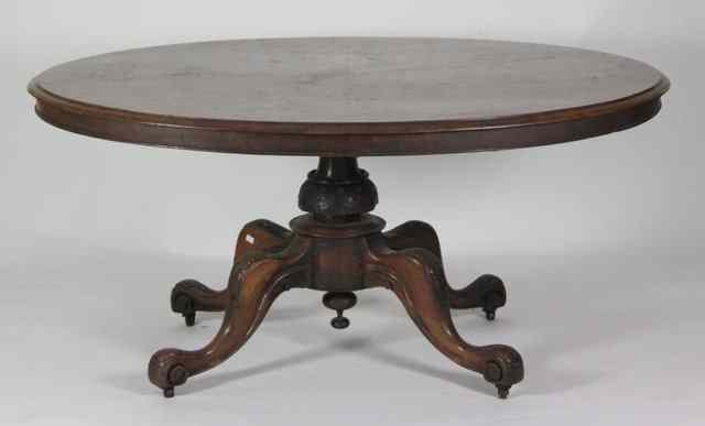 Appraisal: A Victorian walnut loo table the oval top on a