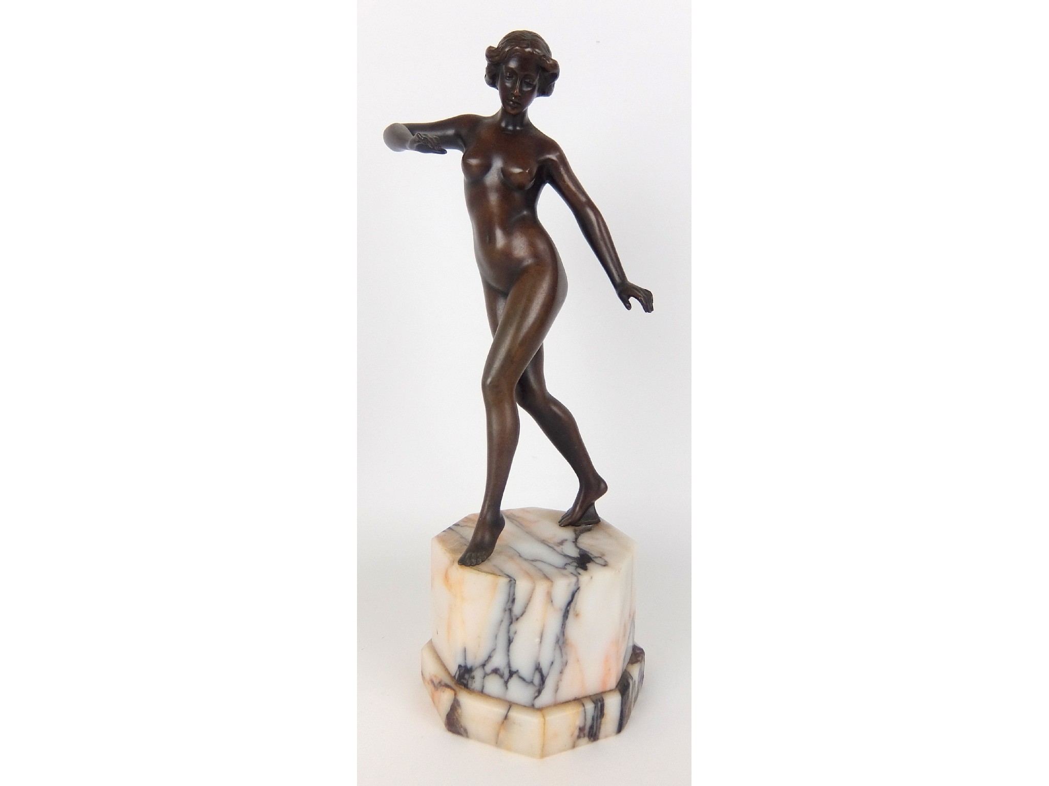 Appraisal: A patinated bronze figure of a female nudeon octagonal marble