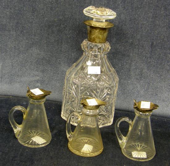 Appraisal: A SILVER MOUNTED GLASS DECANTER and three silver mounted whisky