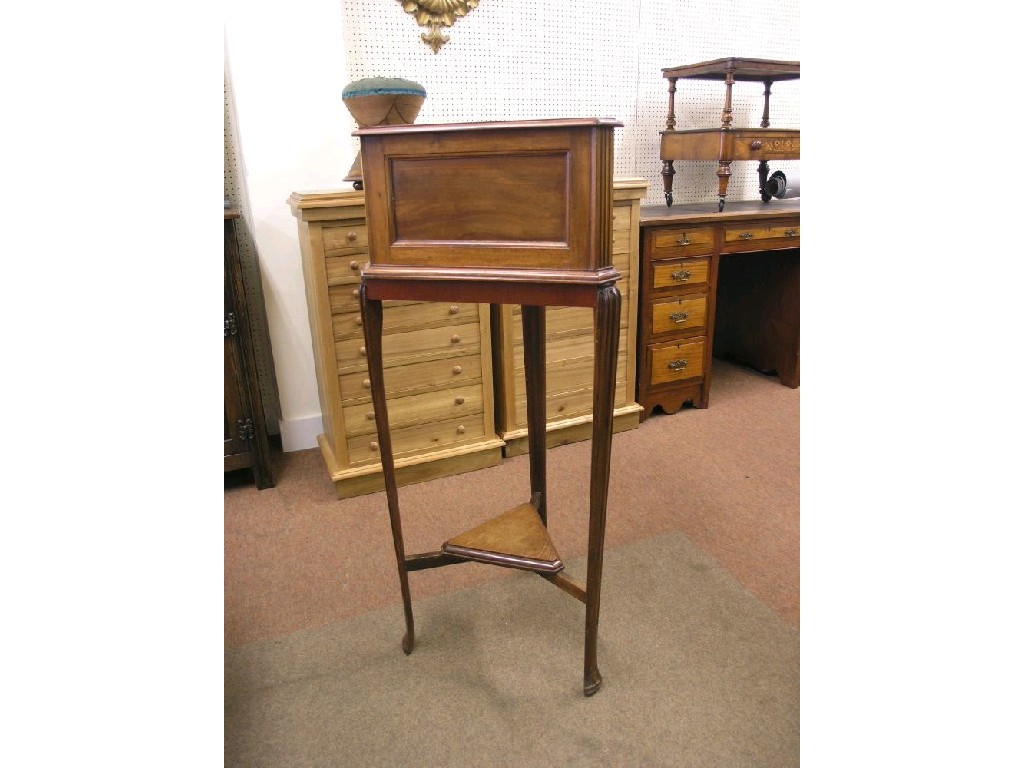 Appraisal: A triangular walnut jardiniere stand panelled stand raised upon three