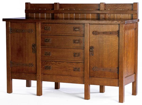 Appraisal: GUSTAV STICKLEY Eight-legged sideboard no with plate rail chamfered back