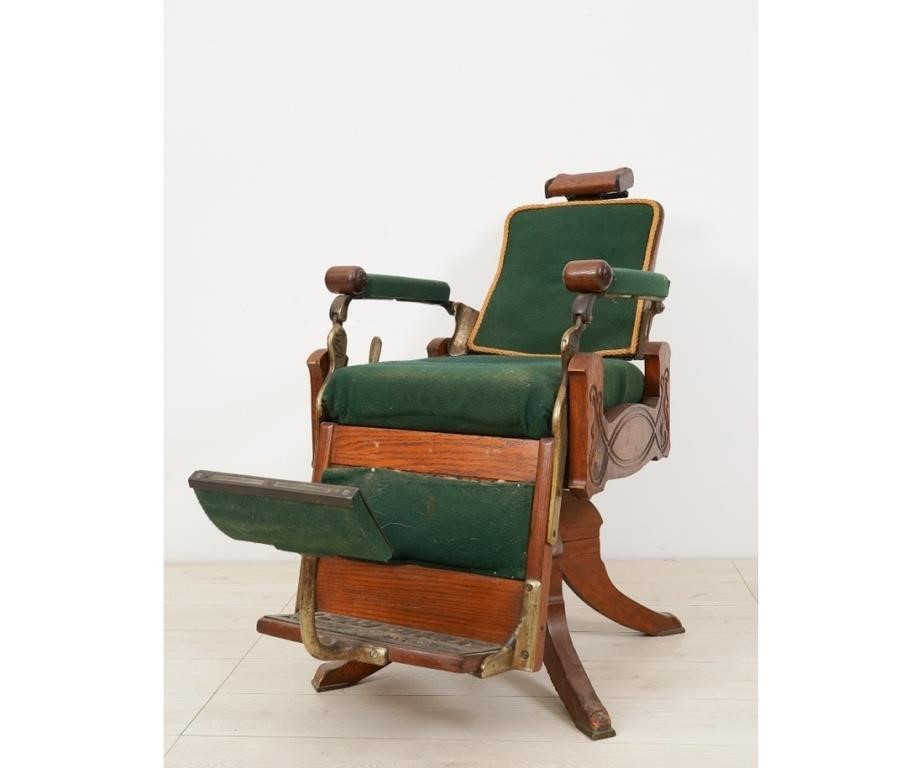 Appraisal: Koch's oak and wrought iron adjustable barber's chair the foot