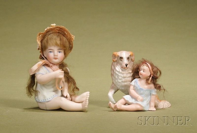 Appraisal: Two Bisque Children Figurines Germany c a seated child with