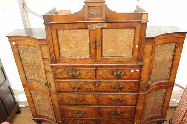 Appraisal: AN ANTIQUE WALNUT WARDROBE the central section with material lined