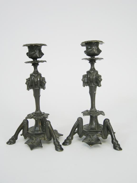 Appraisal: A pair of bronze Candlesticks with horse heads motifs to