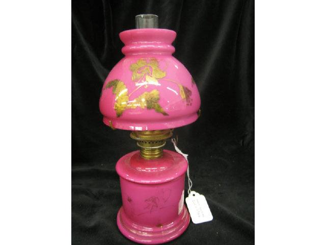 Appraisal: Victorian Miniature Oil Lamp cranberry cased gold floral matching shade