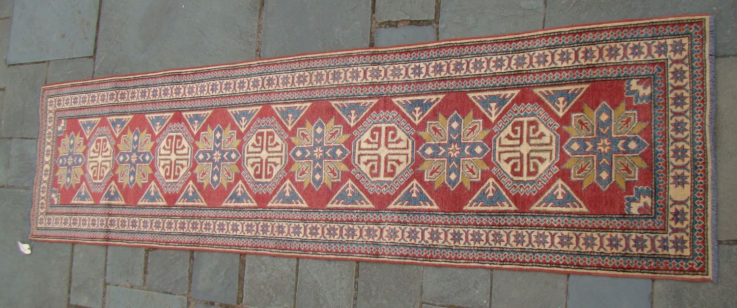 Appraisal: ORIENTAL RUG KAZAK-DESIGN RUNNER ' x ' Alternating cross-shaped and