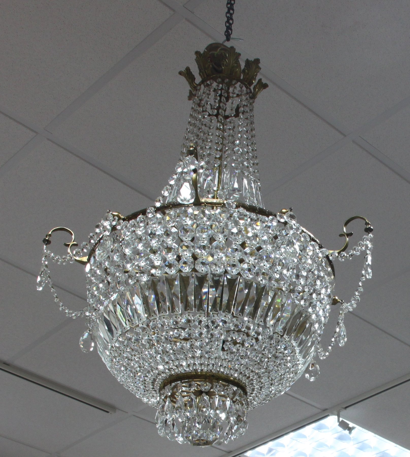 Appraisal: A cut-glass chandelier hung prismatic drops and swags of drops