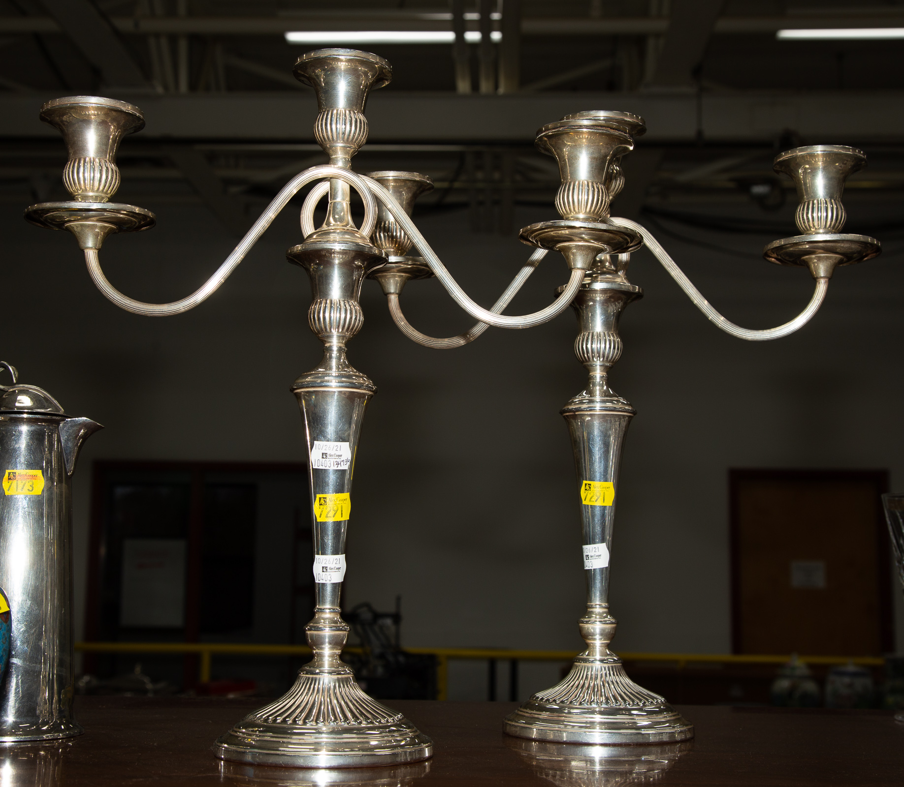 Appraisal: A PAIR OF STERLING WEIGHTED THREE-LIGHT CANDELABRA Converts to single