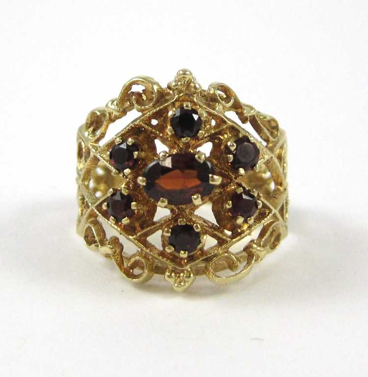 Appraisal: GARNET AND FOURTEEN KARAT GOLD RING with six round-cut garnets