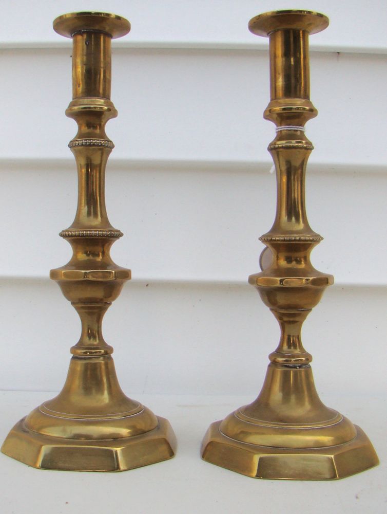 Appraisal: PAIR OF BRASS PUSH-UP CANDLESTICKS th CenturyWith ring beaded stems