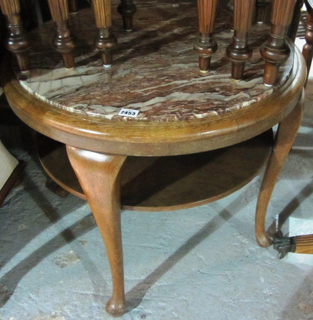 Appraisal: A mid th century oak circular marble top two tier