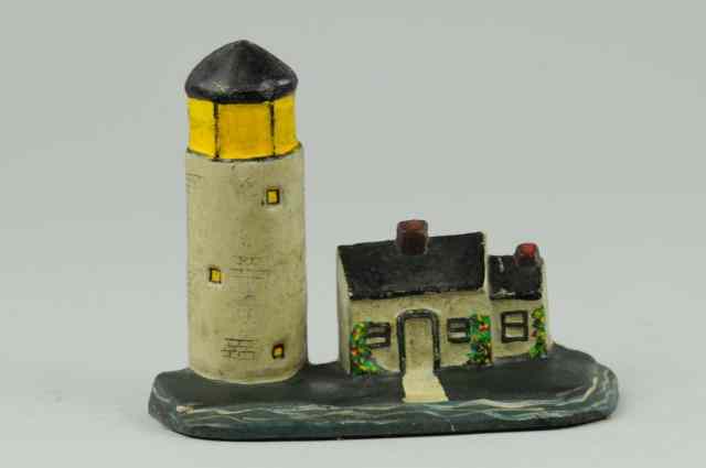 Appraisal: LIGHTHOUSE DOORSTOP Cast iron lighthouse and keeper's house depicted on