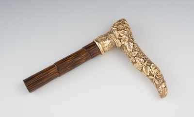 Appraisal: A Repousse Rolled Gold Cane Handle The curving gold handle