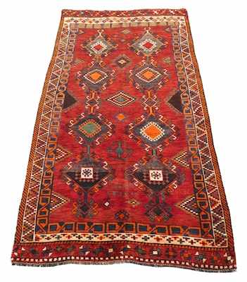 Appraisal: A Signed Kazak Carpet Eight geometric shapes connected with surrounding