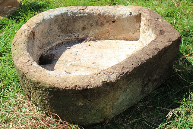 Appraisal: A SMALL SANDSTONE HORSESHOE SHAPED TROUGH with two drainage holes