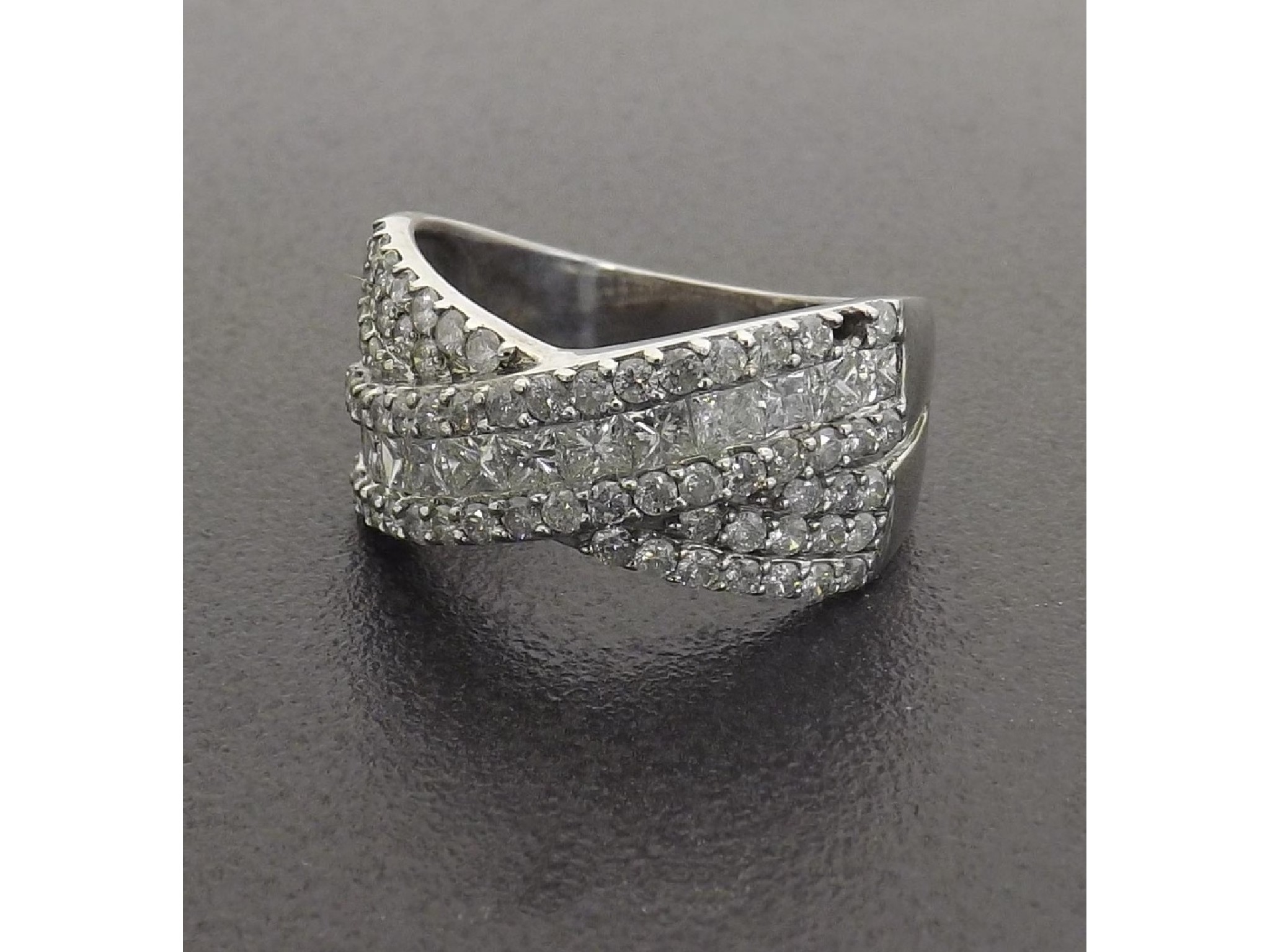 Appraisal: - -A Impressive white gold three row princess and brilliant-cut