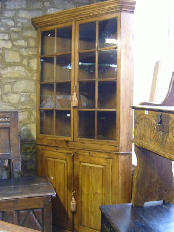 Appraisal: A Georgian style stripped and waxed pine -tier corner cupboard