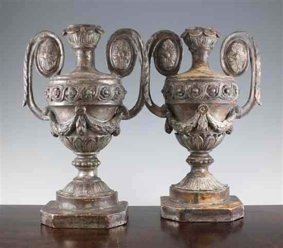 Appraisal: A pair of silver painted carved wood half urn ornaments