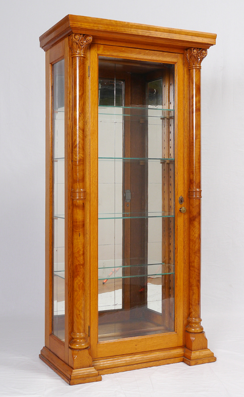 Appraisal: CARVED SATIN WOOD DISPLAY CABINET Carved column stiles mirrored back