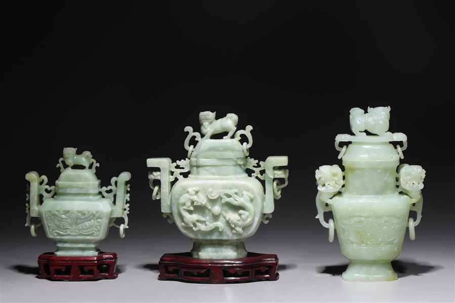 Appraisal: Three Chinese carved hardstone covered vases each in archaistic design