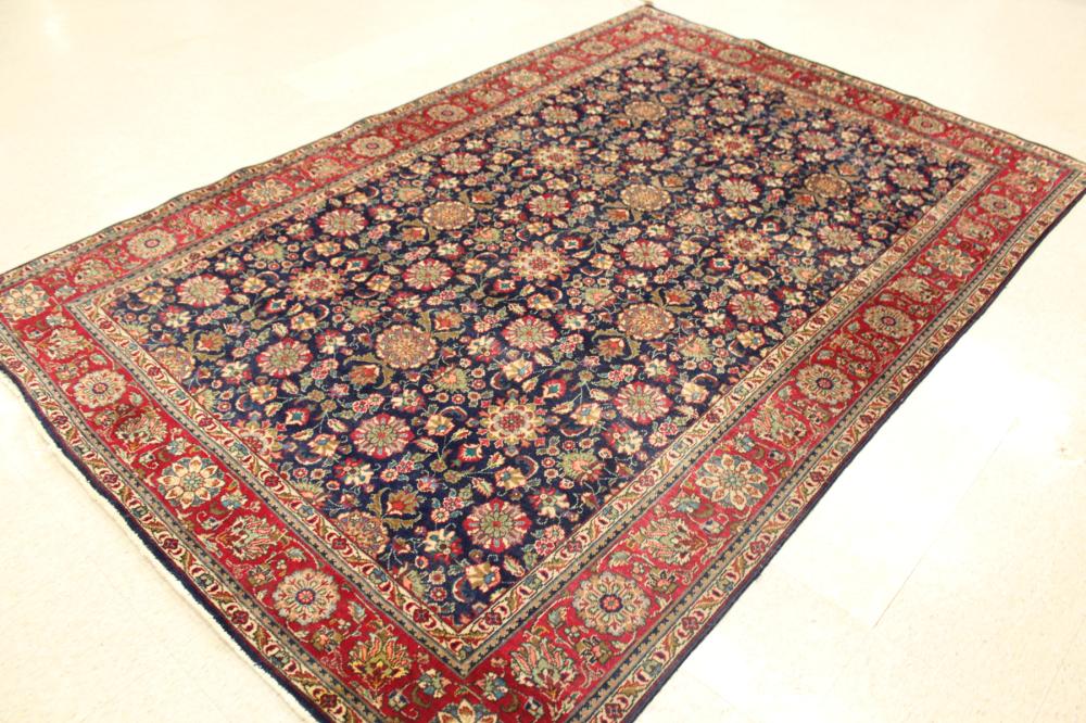 Appraisal: HAND KNOTTED PERSIAN CARPET overall floral design on dark blue