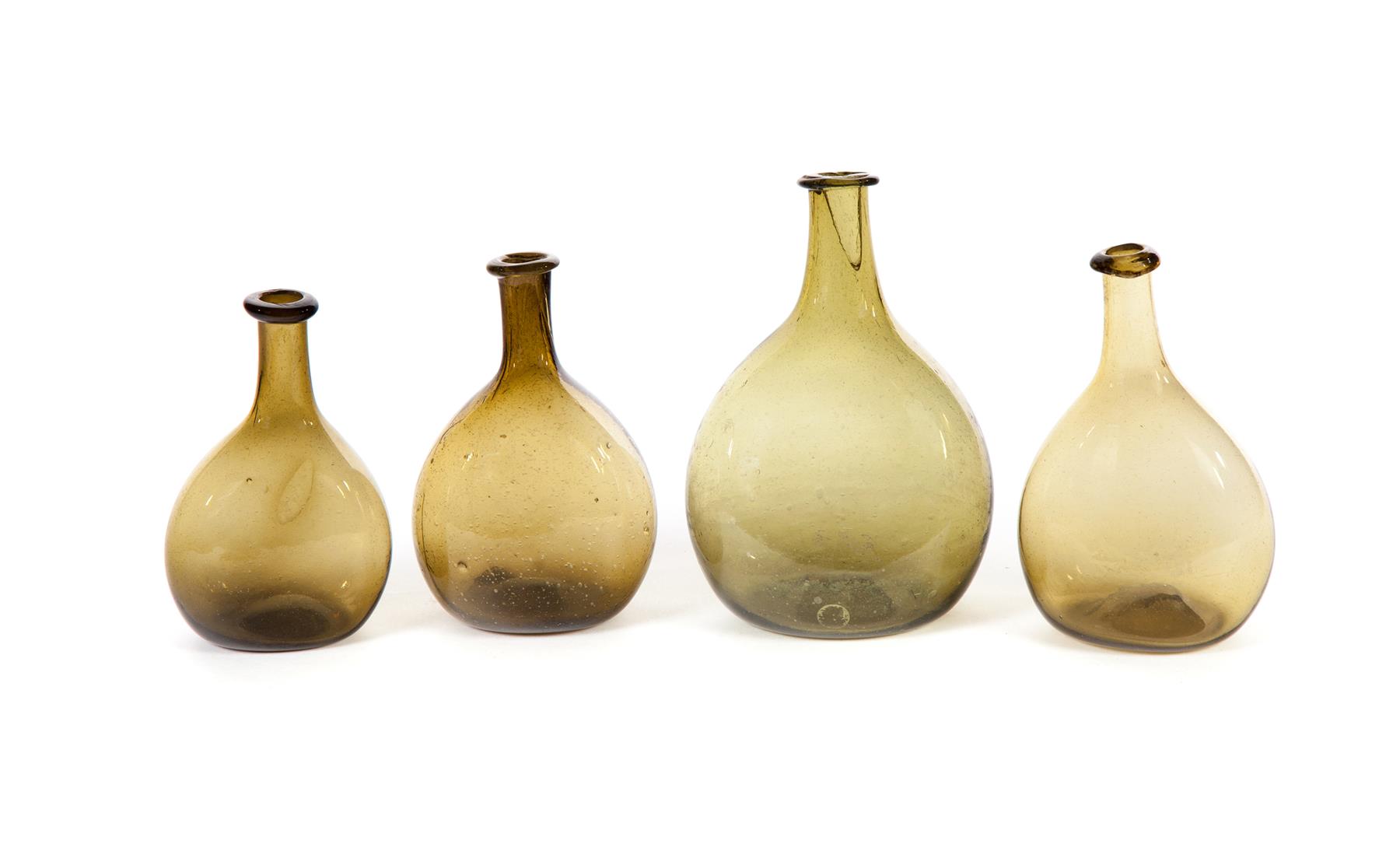 Appraisal: FOUR AMERICAN LUDLOW-TYPE BOTTLES First half- th century Shades of