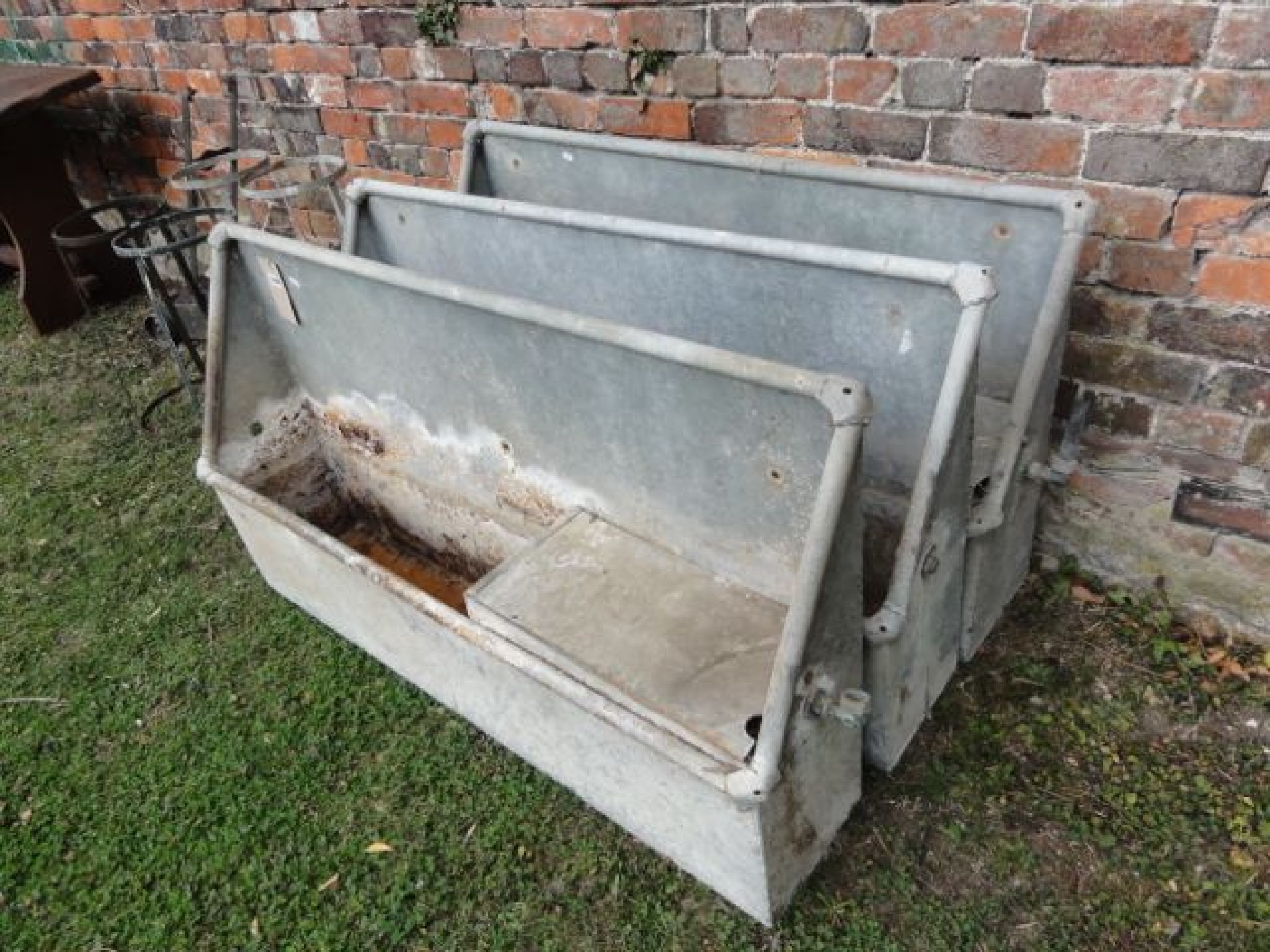 Appraisal: Three reclaimed galvanised steel wall mounted water troughs of rectangular