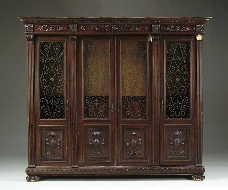 Appraisal: LARGE FOUR DOOR CARVED BOOKCASE This knockdown bookcase has four