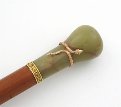 Appraisal: An umbrella with dark green silk covering and a cane