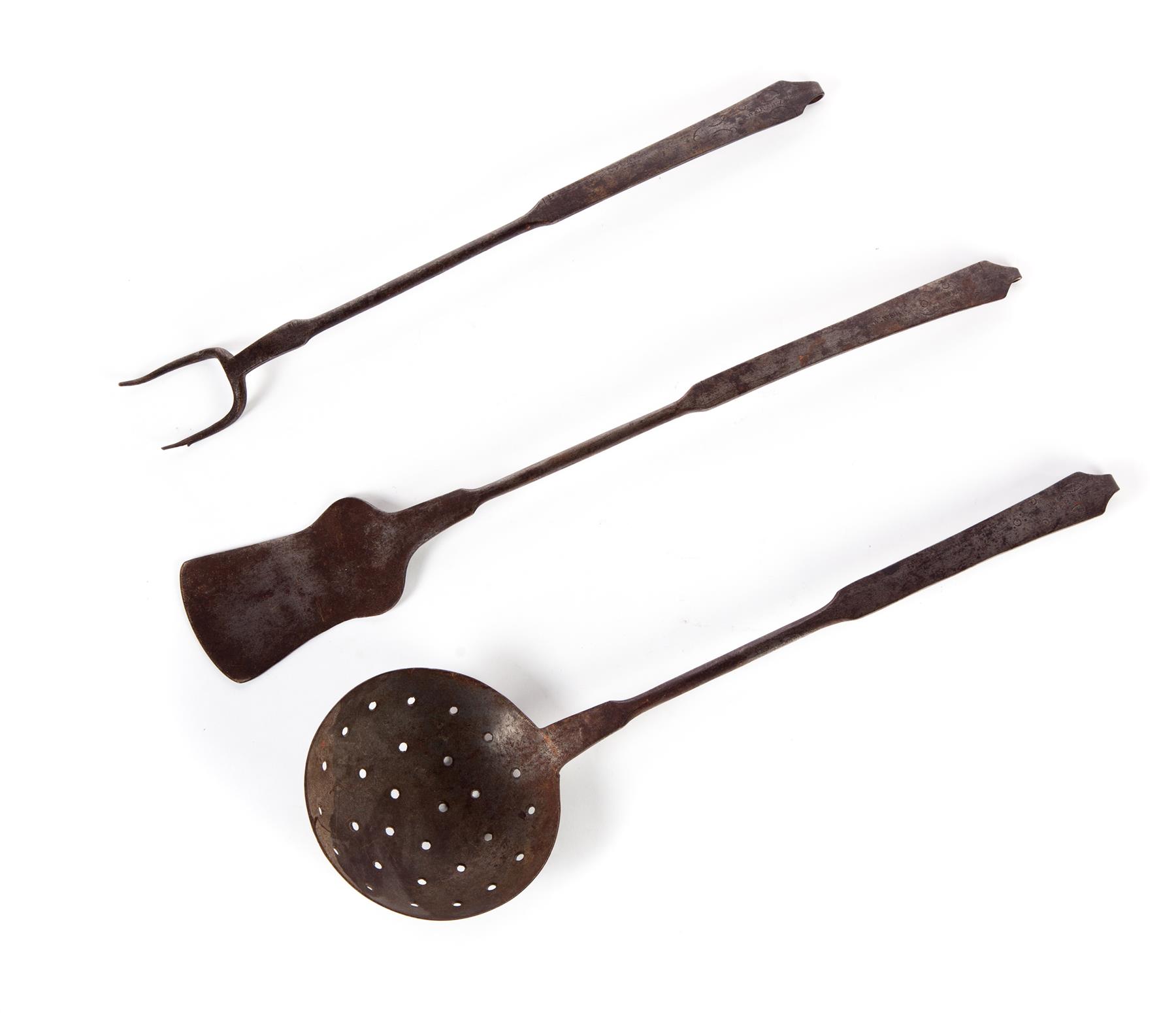 Appraisal: THREE AMERICAN WROUGHT IRON UTENSILS Nineteenth century Strainer fork and