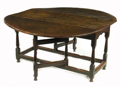 Appraisal: An early th century oak drop leaf dining table the