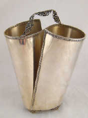 Appraisal: A white metal tests standard silver double napkin holder height