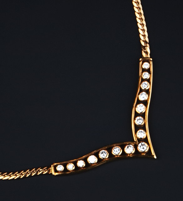 Appraisal: A DIAMOND SET PENDANT NECKLACE the openwork wishbone-shaped panel centred