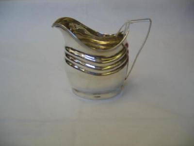 Appraisal: A GEORGIAN CREAM JUG of dished oval form with reeded