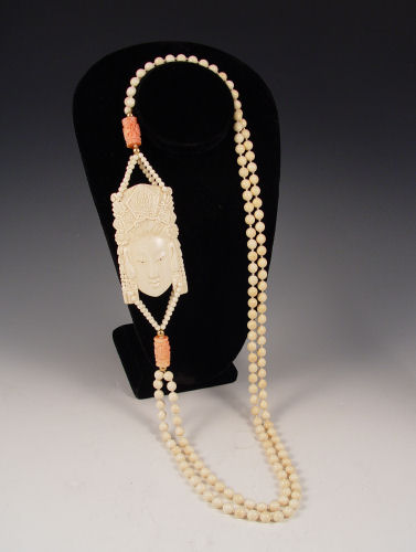 Appraisal: CHINESE IVORY CORAL NECKLACE Double strand of ivory beads off-set