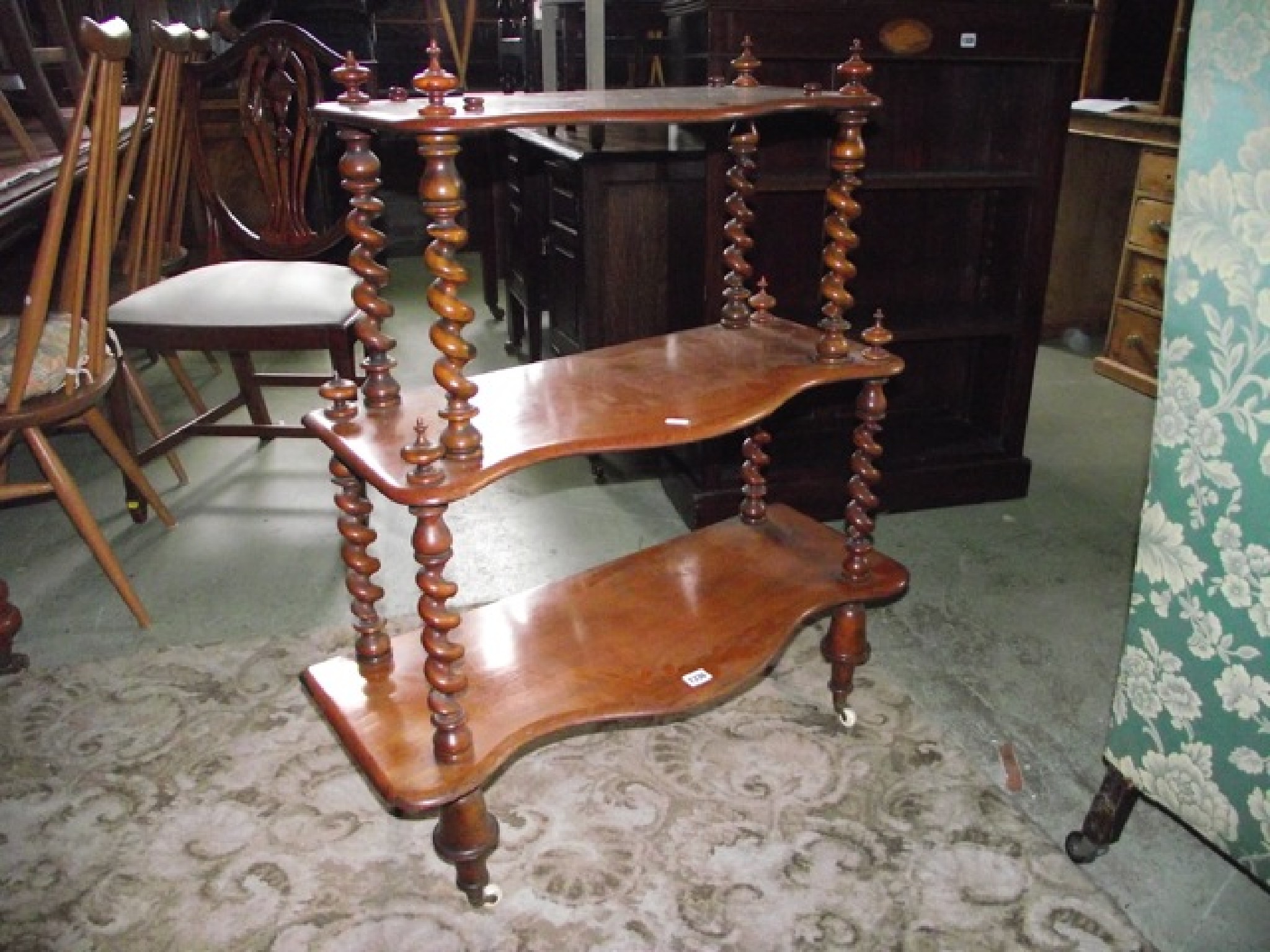 Appraisal: A Victorian mahogany floor standing three tier graduated whatnot the