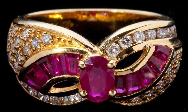 Appraisal: Ruby and Diamond Cross Over Ringcentering on one oval cut