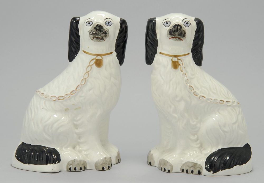 Appraisal: PAIR OF STAFFORDSHIRE FIGURES OF SPANIELS Circa In black and