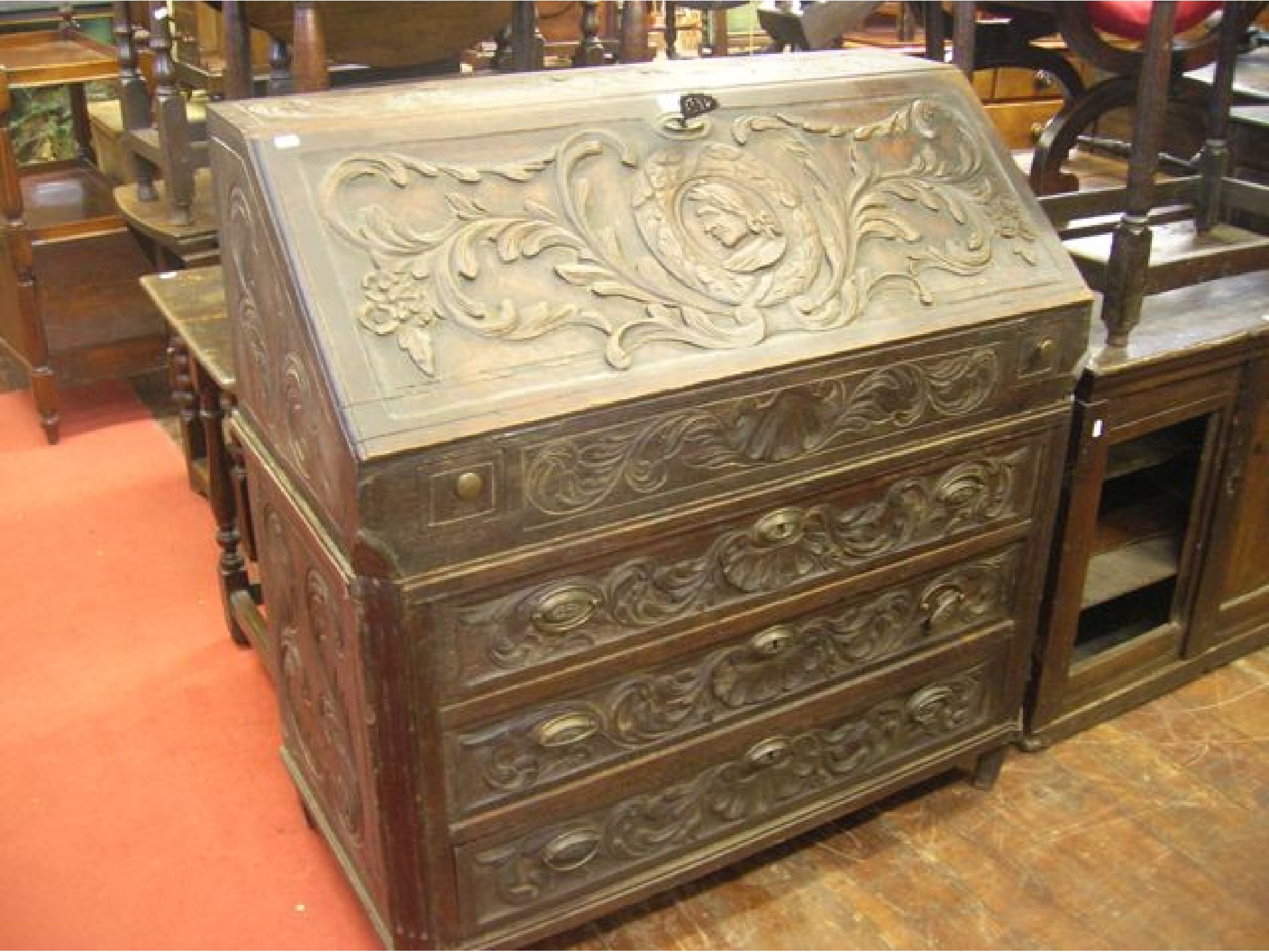 Appraisal: A substantial Georgian oak bureau of three long graduated drawers