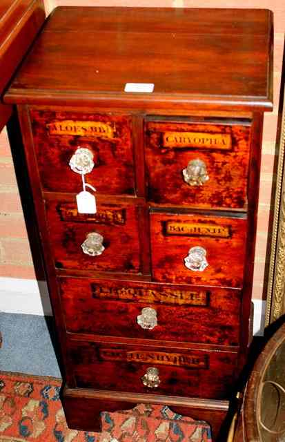 Appraisal: A MAHOGANY CHEMIST CABINET fitted four short deep drawers and