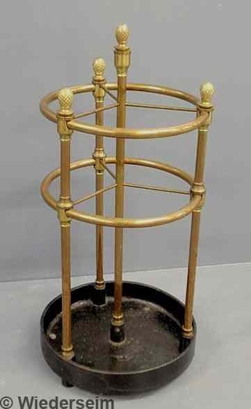 Appraisal: Brass umbrella stand th c with a circular black metal