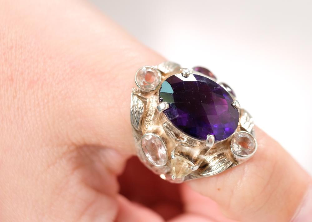 Appraisal: Sterling silver ring set with x mm oval faceted amethyst