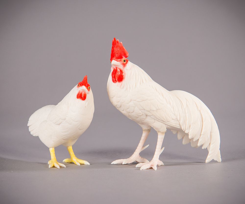 Appraisal: Japanese Ivory Carved Chicken and Rooster Japanese Ivory carved chicken