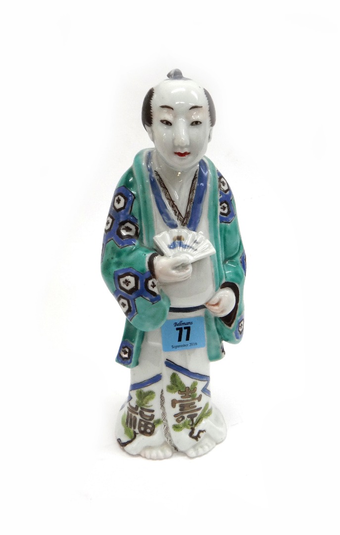 Appraisal: A Japanese porcelain figure th century standing holding a fan